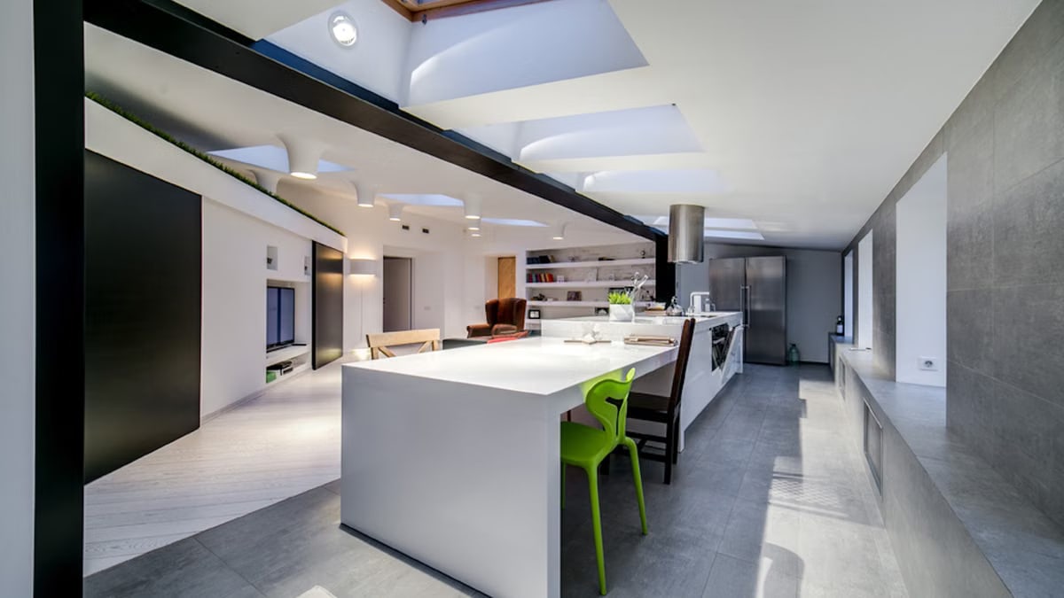 Sleek open-concept kitchen with modern and minimalist design elements and skylights.